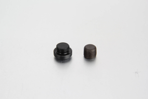 A crisp, white-background studio shot of a steel DIN 908 internal hexagon socket screw plug highlighting its precision-machined sharp metal sealing edge.