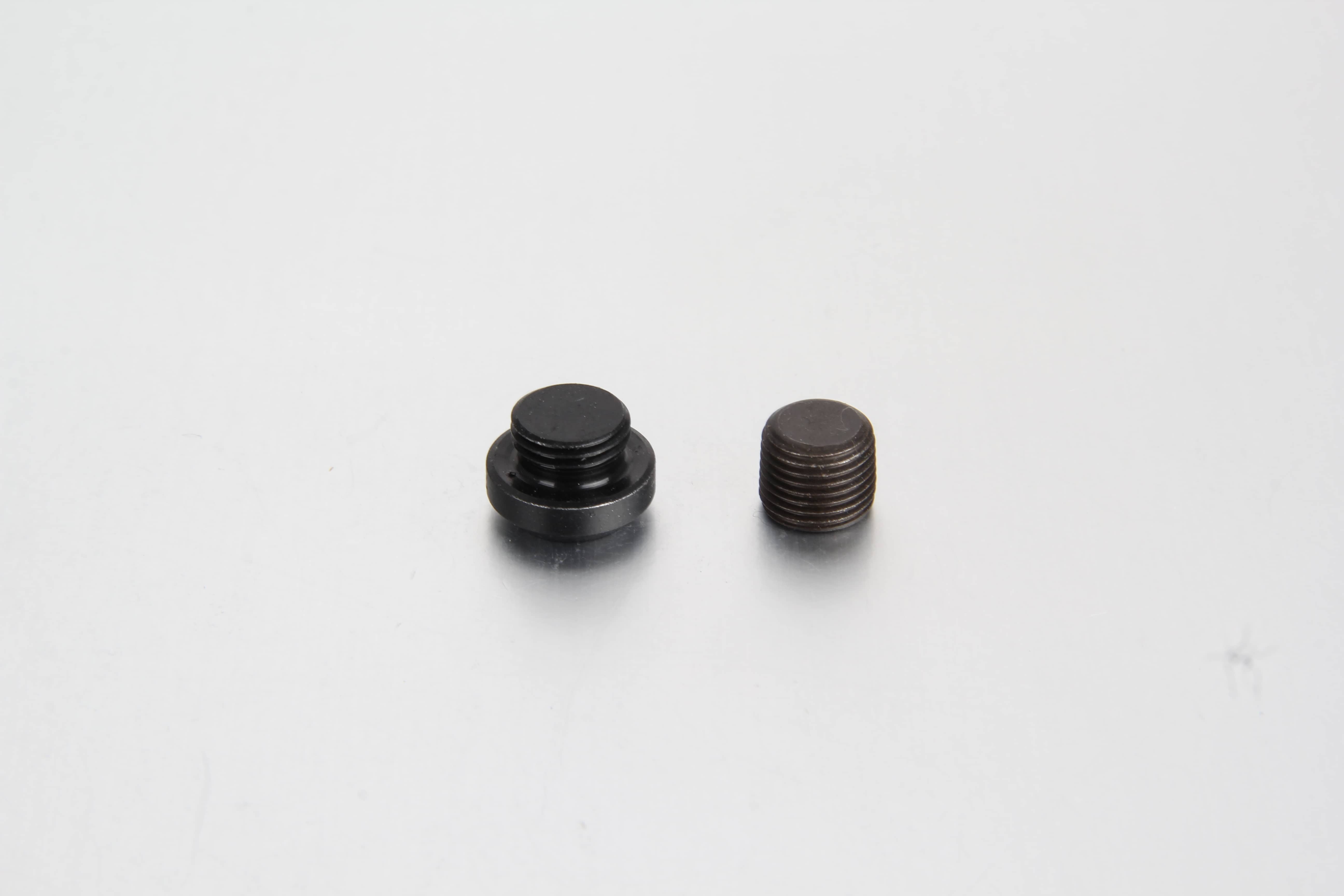 A crisp, white-background studio shot of a steel DIN 908 internal hexagon socket screw plug highlighting its precision-machined sharp metal sealing edge.