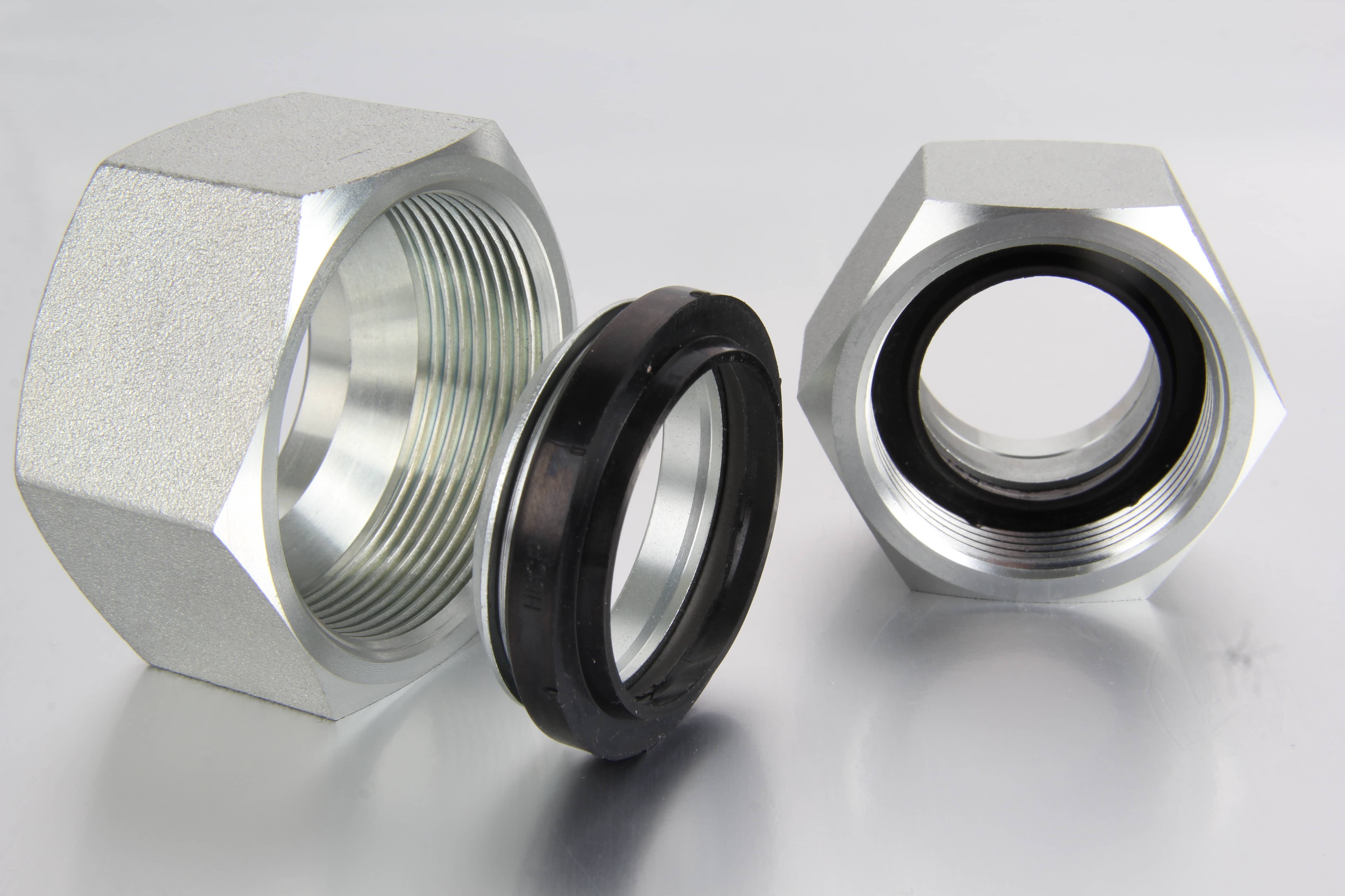  An assembled view of a DIN 2353 hydraulic tube compression fitting showing the connection union body, the soft seal cutting ring, and the compression nut arranged linearly.