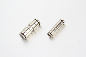 Push-in straight union fitting installed in a centralized lubrication system on industrial machinery, connecting nylon tubing to lubrication points