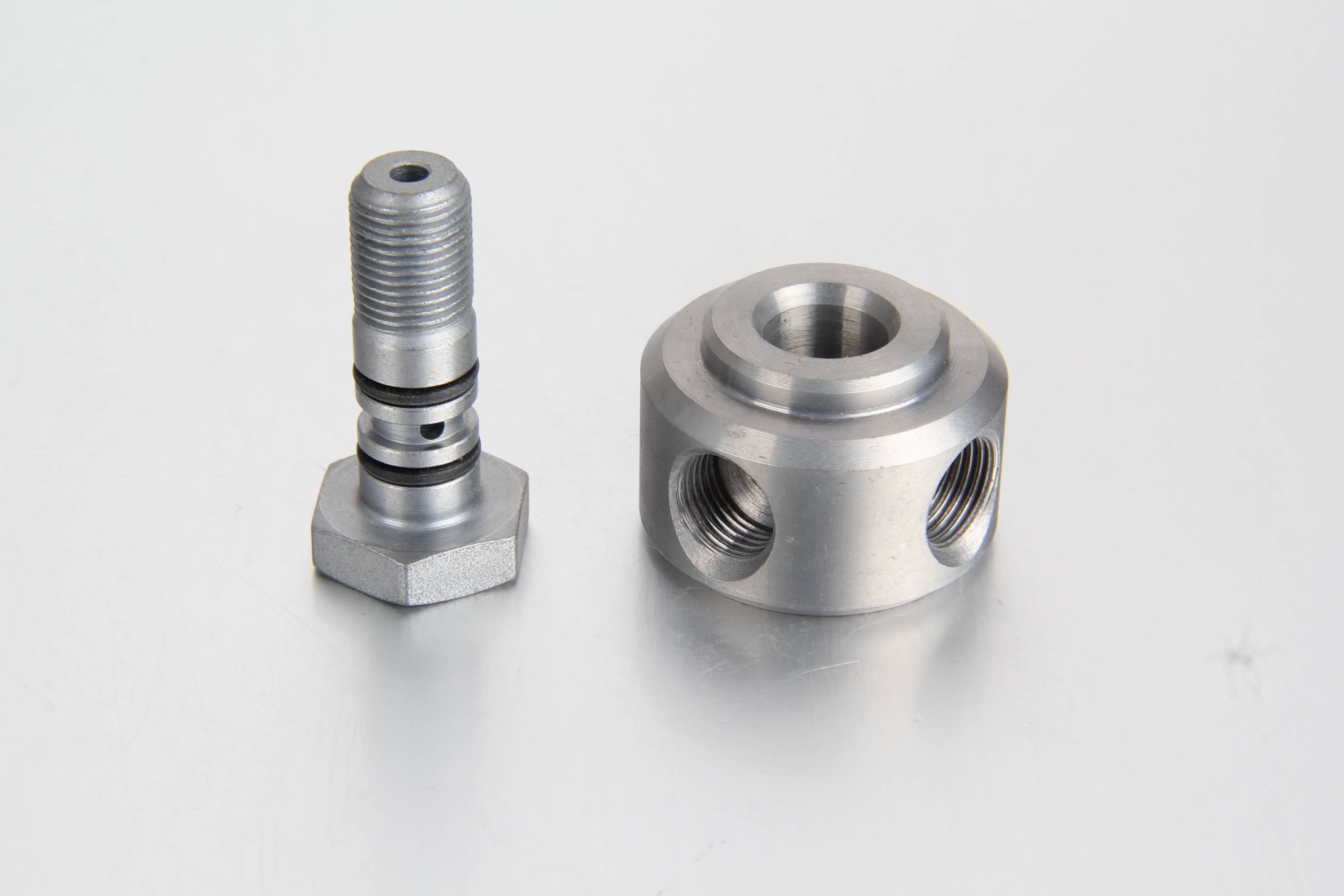 High pressure zinc-nickel plated steel lubrication banjo fitting and matching fluid pass-through bolt designed for centralized grease lines.
