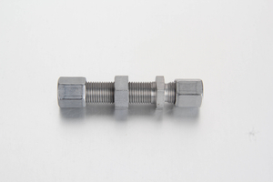 Metric compression straight bulkhead fitting assembly joining two identical diameter grease lines through a panel wall.