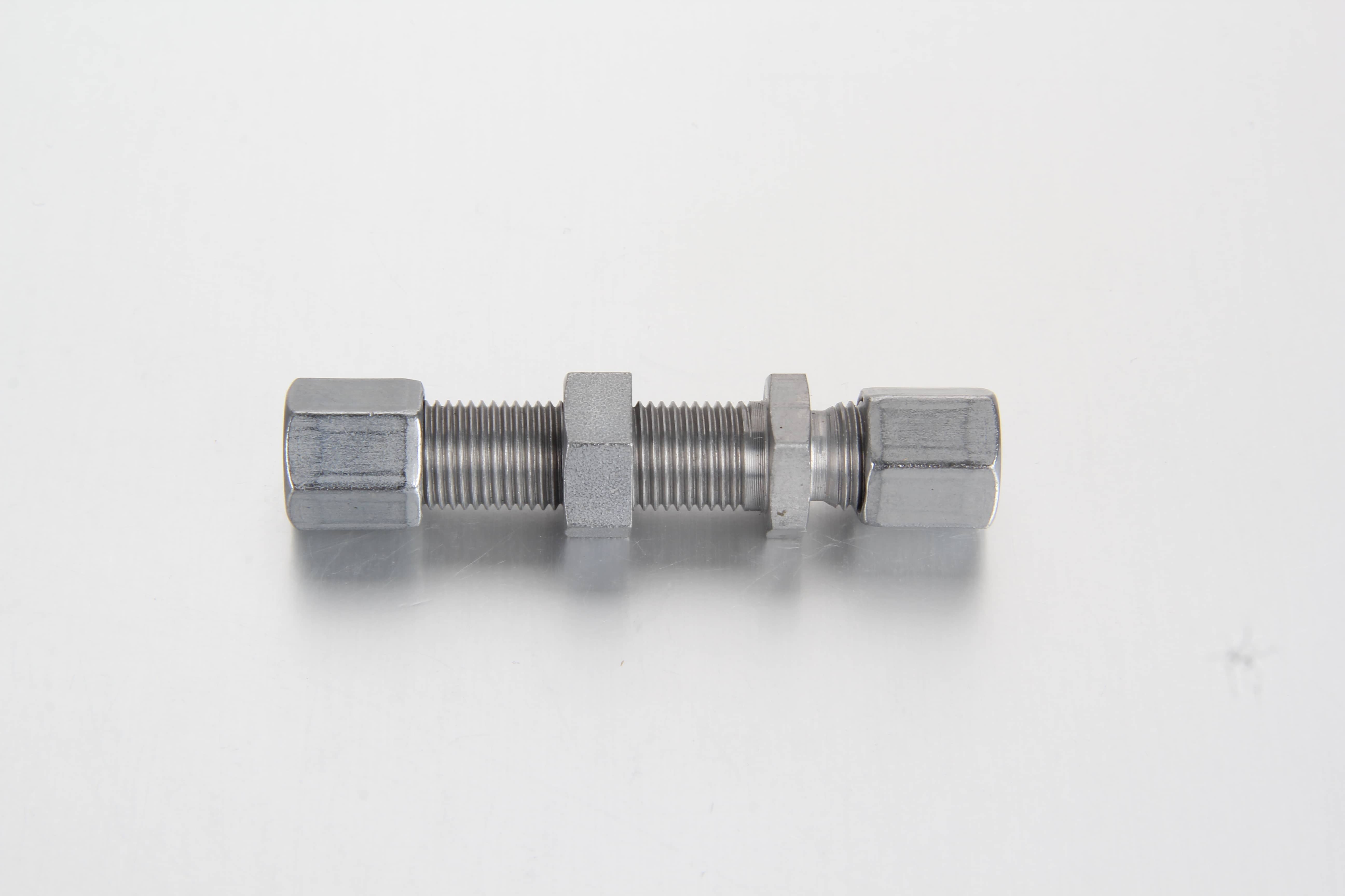 Metric compression straight bulkhead fitting assembly joining two identical diameter grease lines through a panel wall.