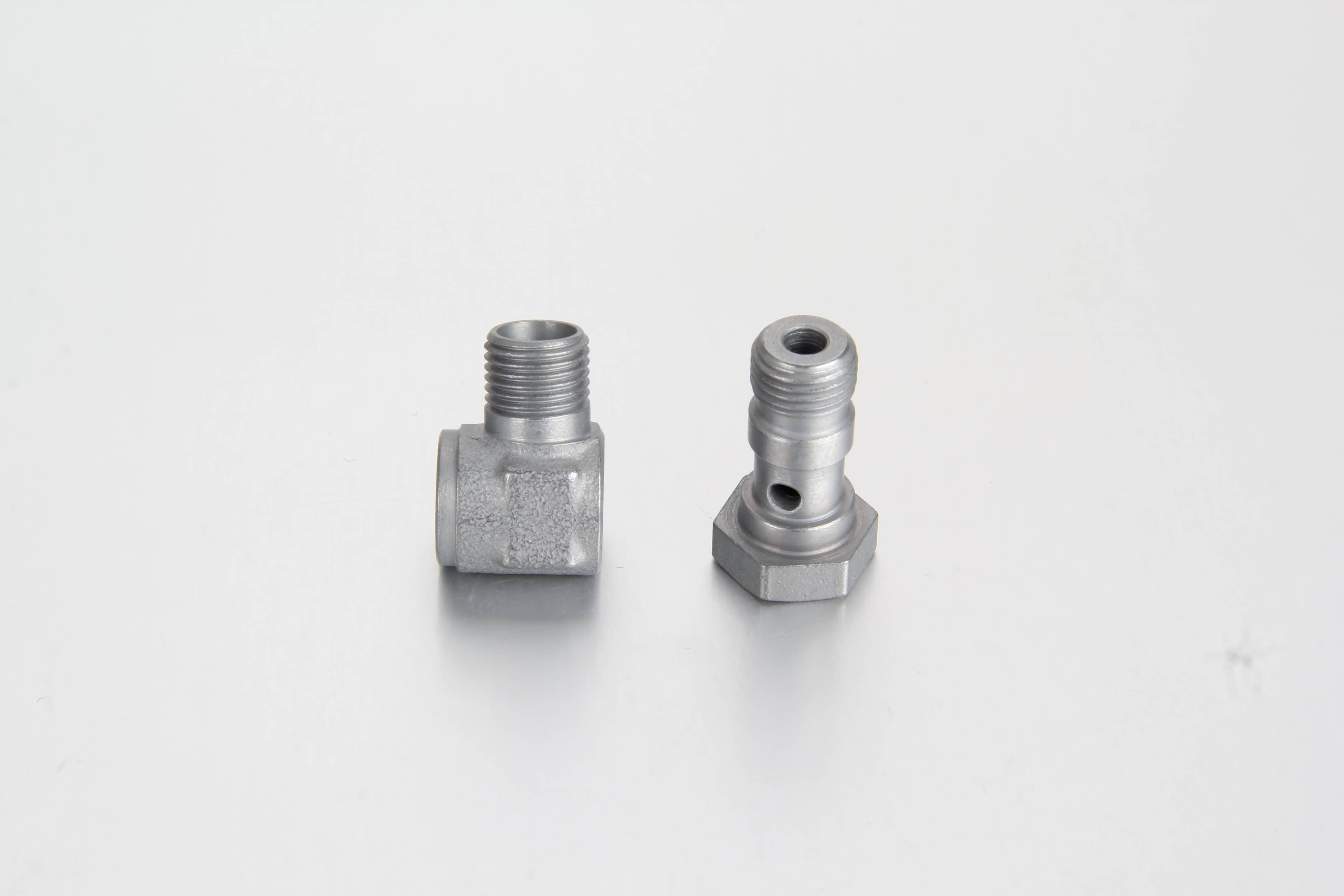 Bulk manufacturing quality control, cross-hole alignment verification, and thread testing of metric compression banjo elbow couplings in an ISO facility.
