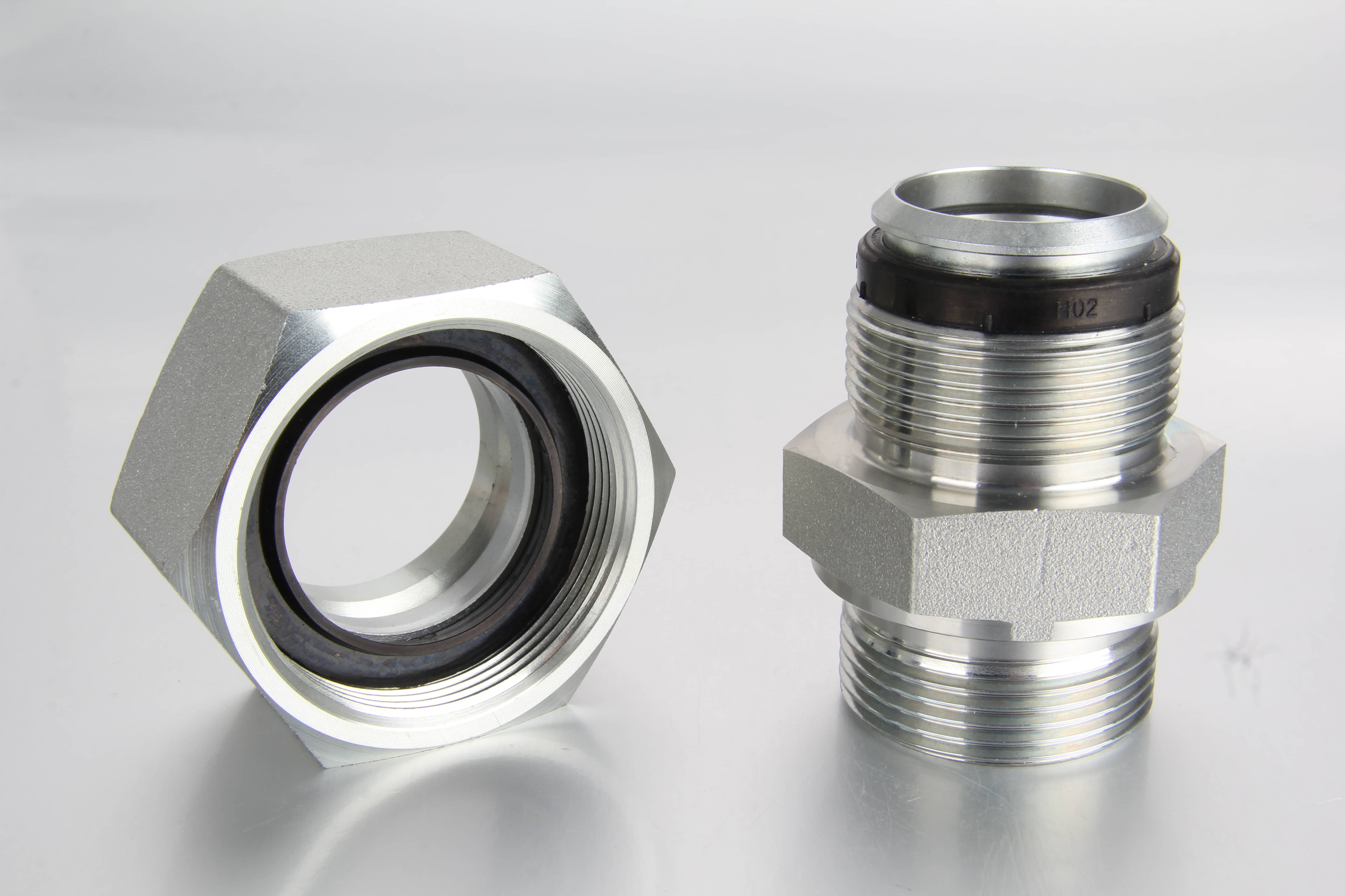 A quality control technician using a digital caliper to inspect the precise dimensions of a zinc-nickel plated soft seal cutting ring fitting inside a factory setting.