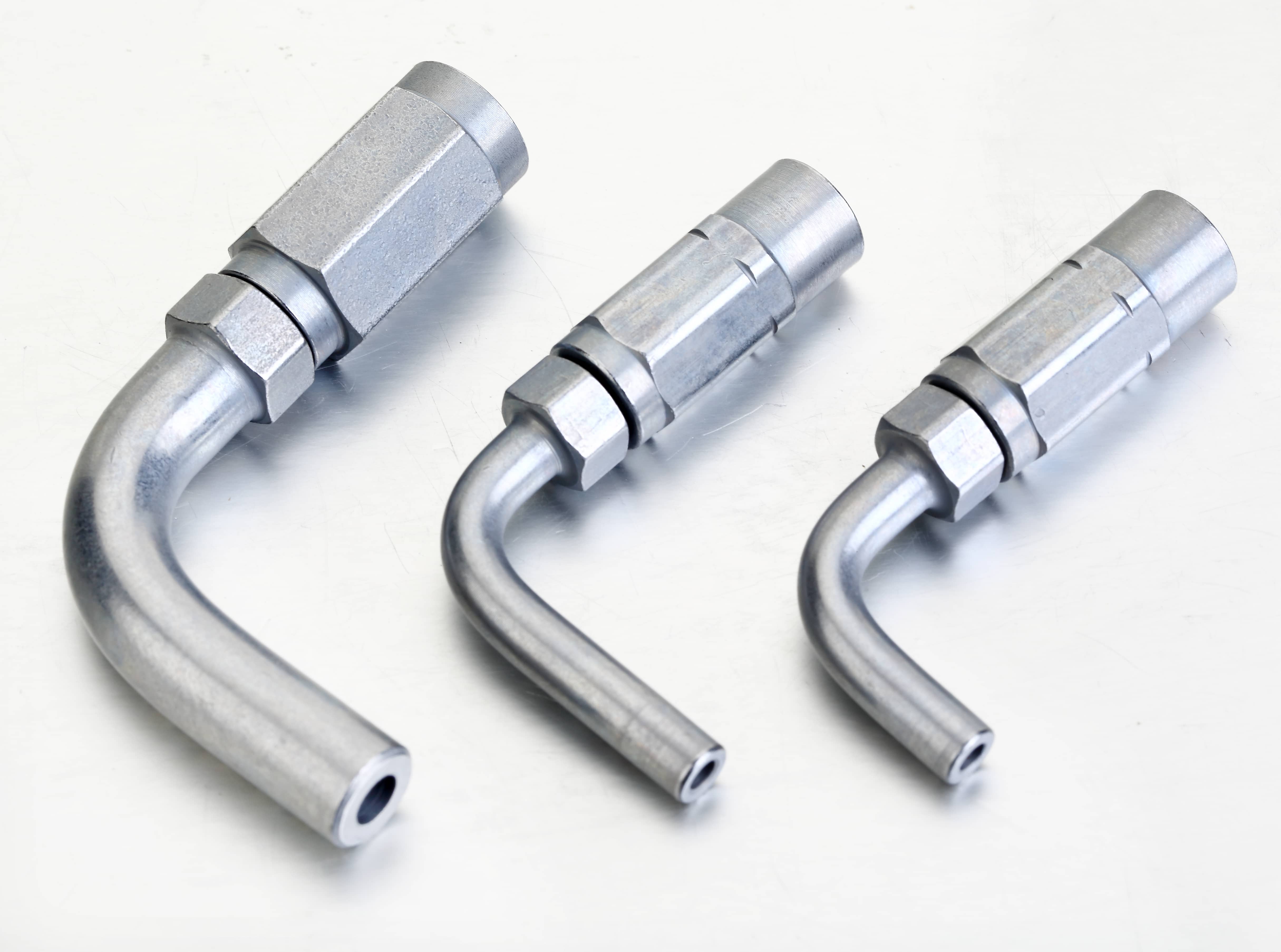 Exploded installation diagram showing a high-pressure grease hose, left-hand thread screw sleeve, and a 90° right-angle elbow hose stud pipe socket