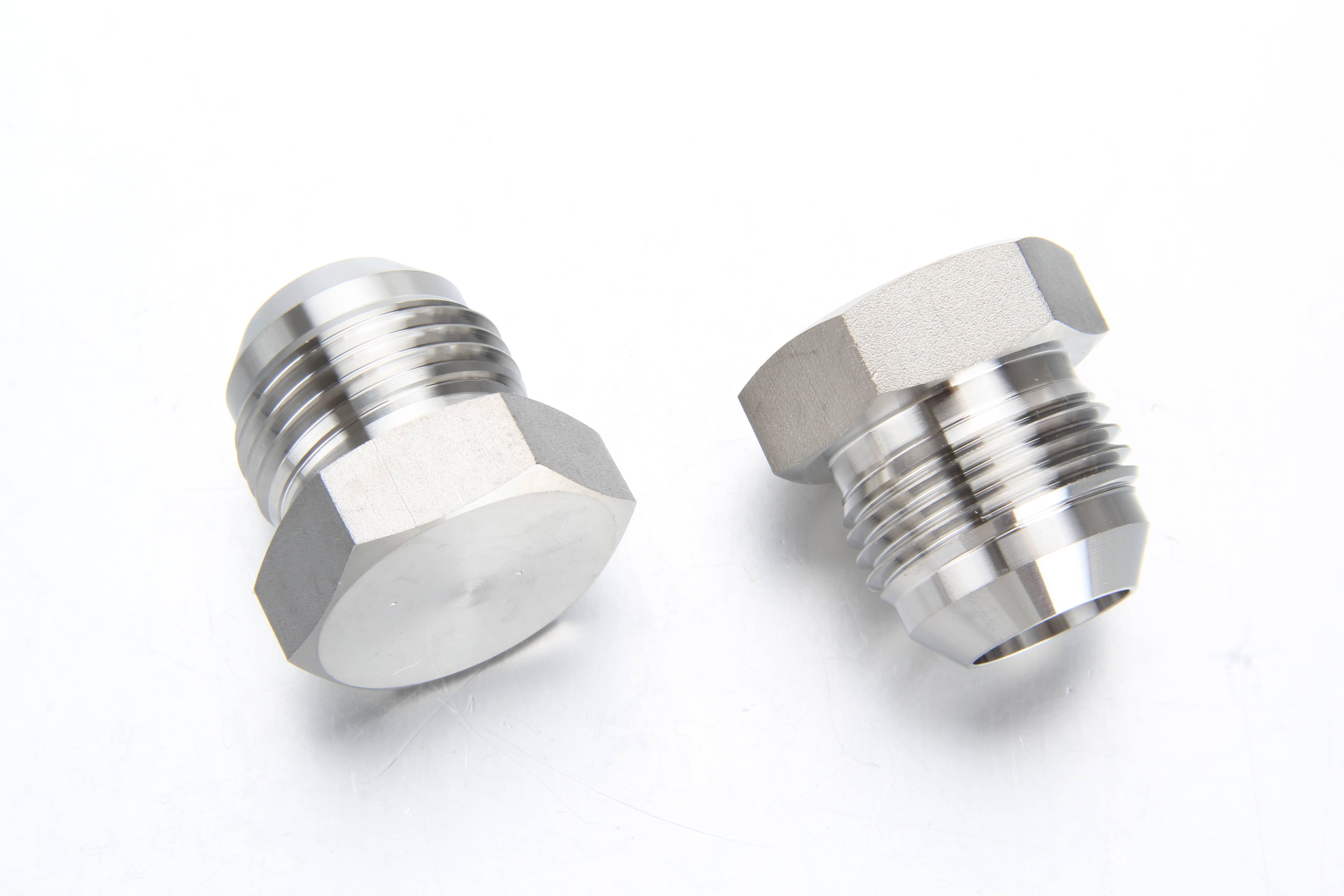 Complete family of thick-walled high pressure stainless steel fittings including forged elbows, tees, and high-pressure hex nipples.