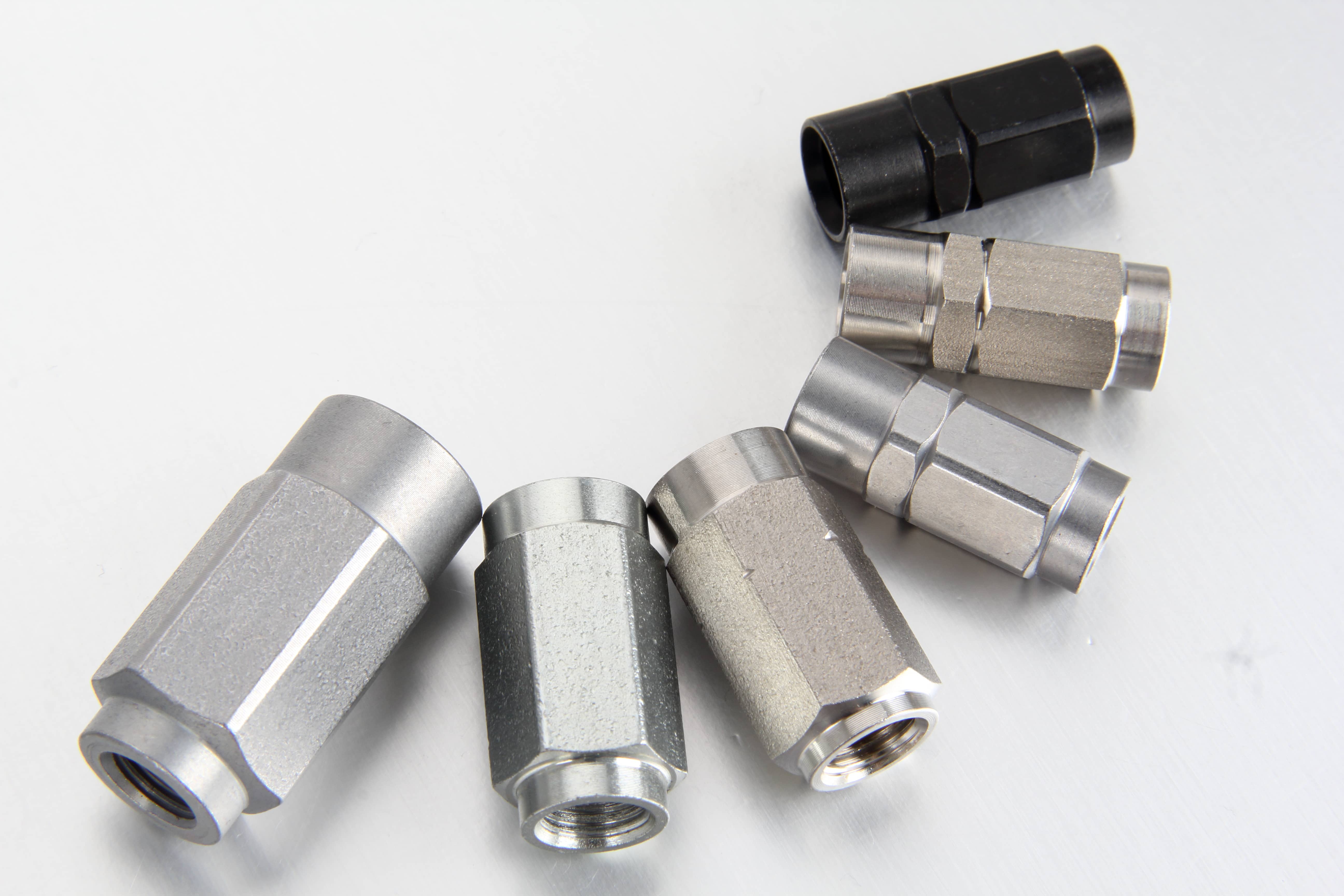 Rigorous production block inspection and quality auditing of specialized 400 bar grease hose fittings inside an ISO facility.