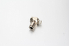 A high-pressure nickel-plated brass swiveling banjo quick connector push-in fitting with a perforated hollow bolt for centralized lubrication systems.
