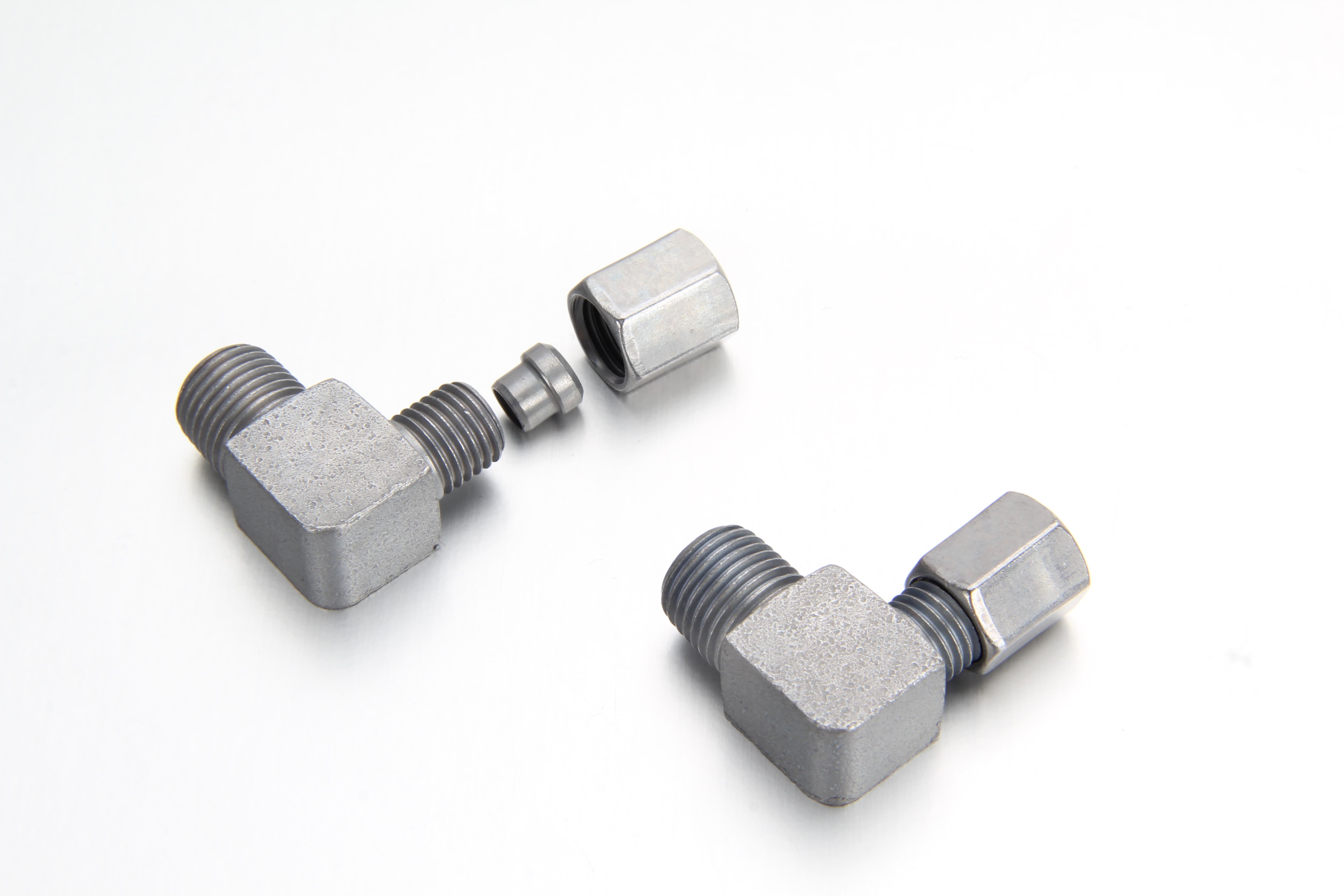 Side-by-side comparison of BSPT and NPT taper threads machined on 90 degree cutting ring elbows.