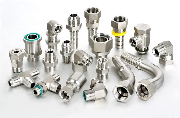 Comprehensive range catalog display of Fitsch stainless steel fluid components, featuring hydraulic tube fittings, compression cutting rings, adapters, one-piece crimped hose fittings, and separate ferrules for industrial fluid systems and data center loops.