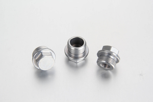 A professional white-background studio shot of a steel DIN 910 external hexagon head screw plug highlighting its precision-machined heavy-duty sealing collar face.