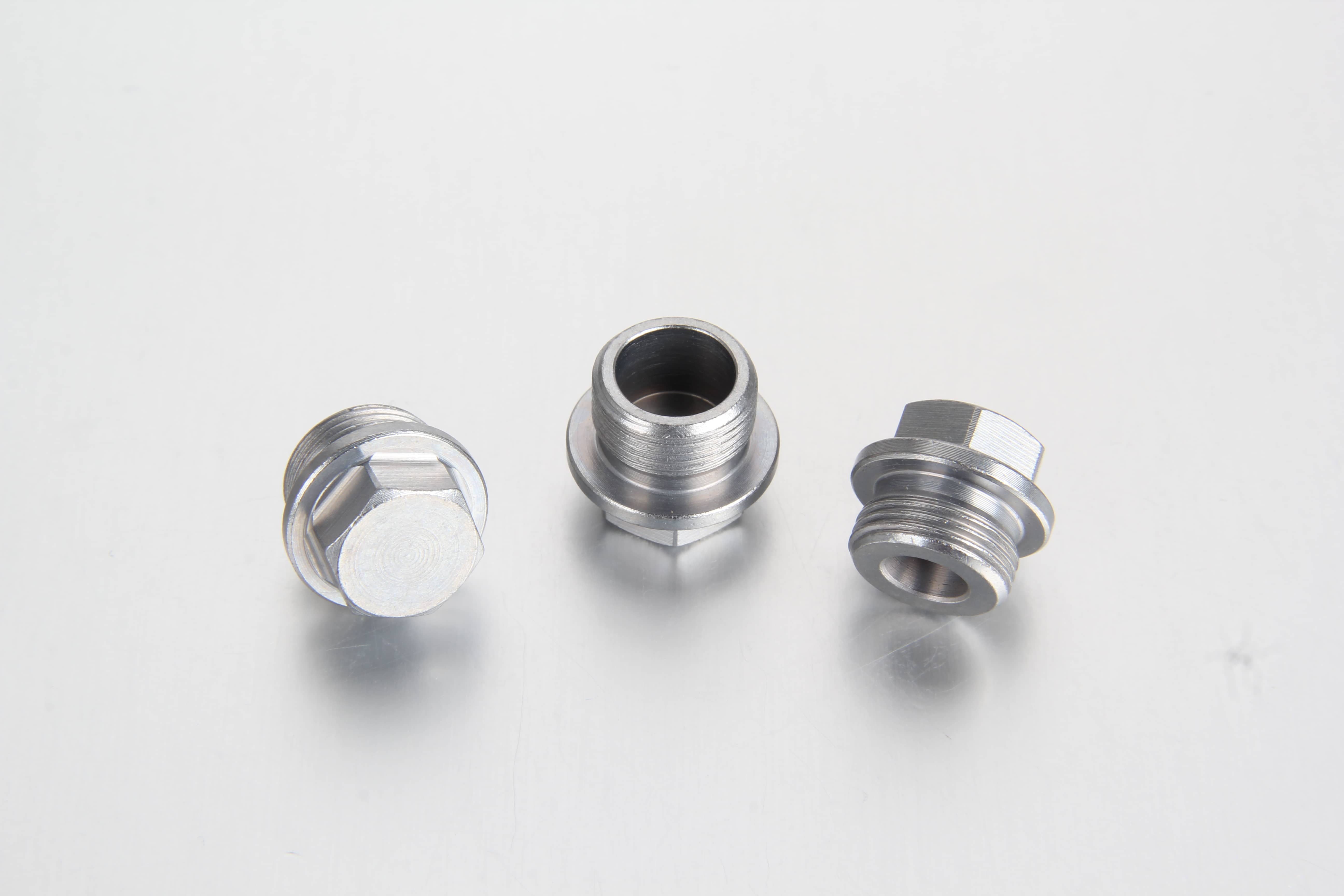 A professional white-background studio shot of a steel DIN 910 external hexagon head screw plug highlighting its precision-machined heavy-duty sealing collar face.