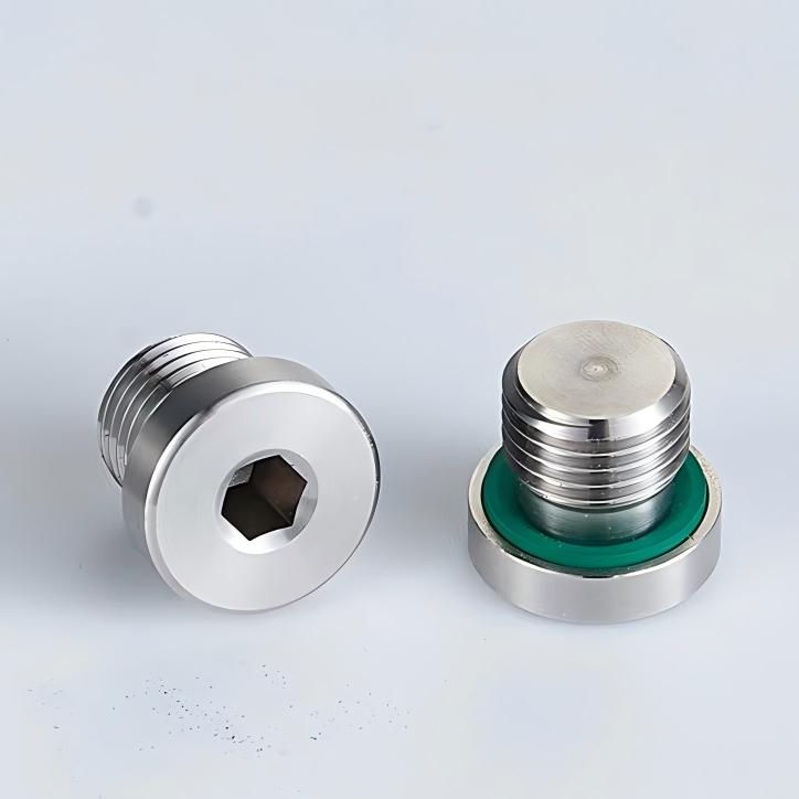 A real-world application photo showing multiple DIN 908 M10x1 soft sealing screw plugs blocking unused outlet ports flush on an automated grease progressive distributor.