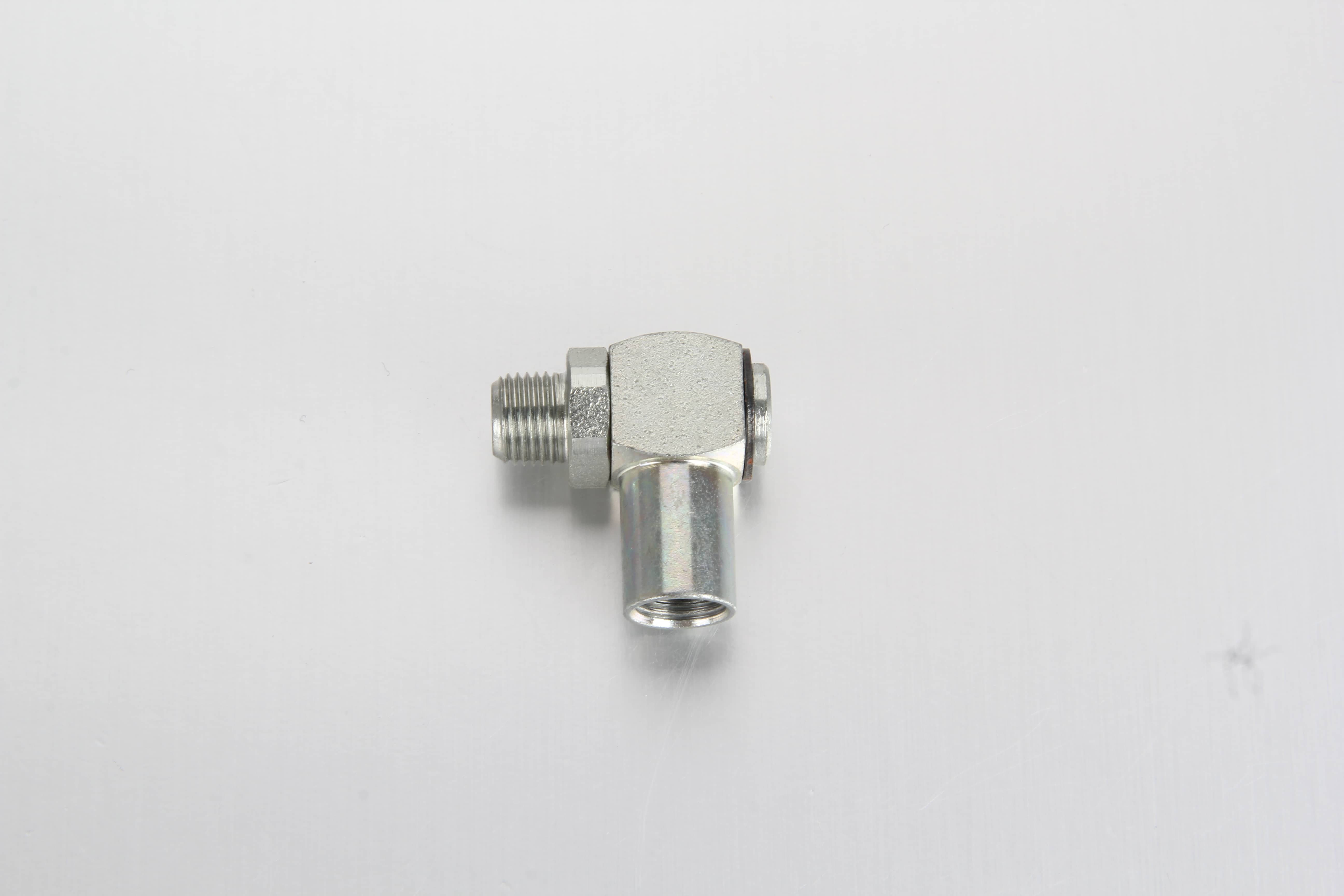 A dynamic multi-angle image with overlay arrows demonstrating the 360-degree continuous swivel movement of a 90-degree lubrication piping adapter.