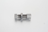 Metric compression straight bulkhead female coupling assembly with an internal female thread on one end and a compression tube connector on the other.