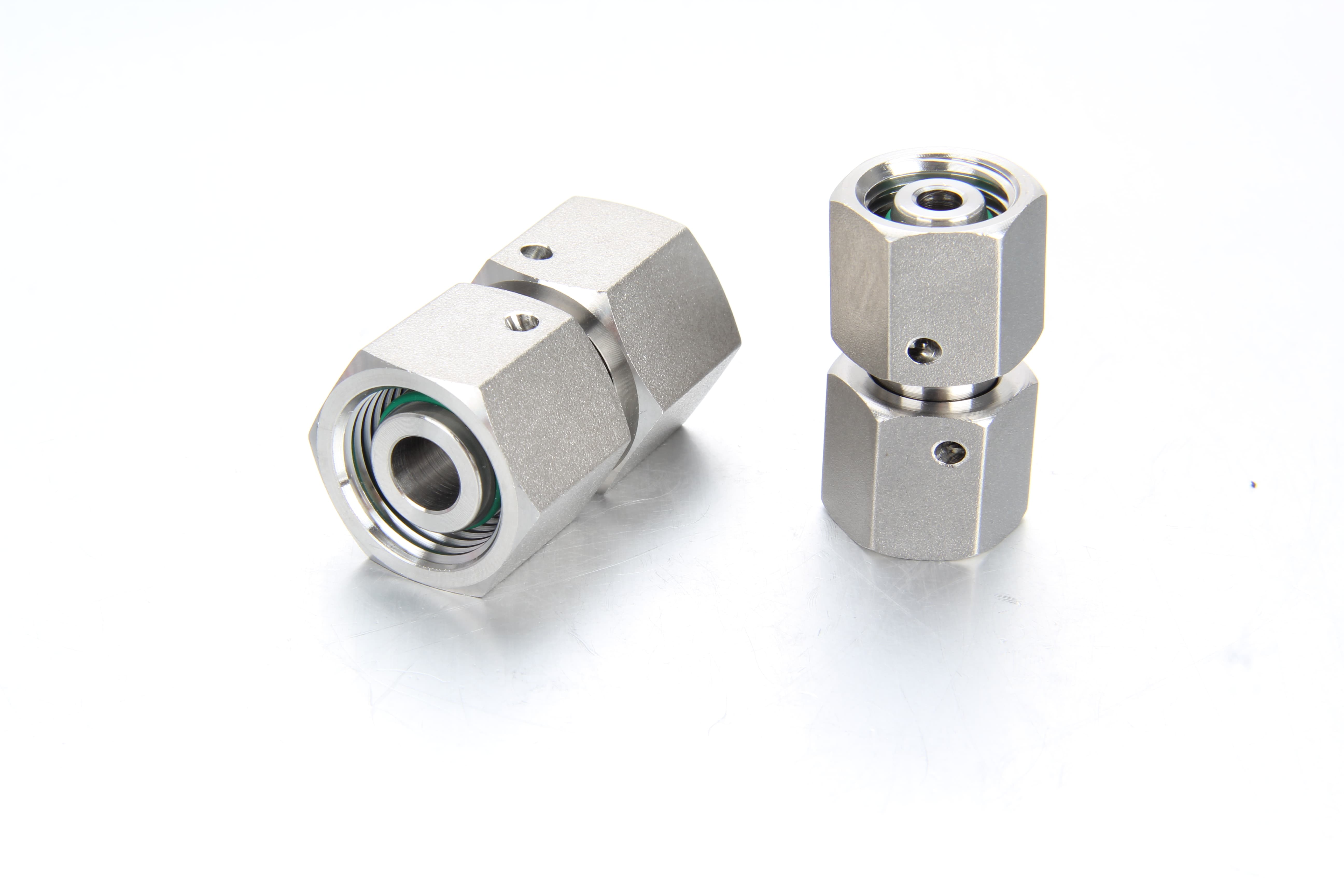 Close-up of a straight stainless steel DIN 2353 metric DKO swivel union fitting adapter with Viton O-ring sealing.