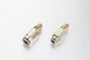 A high-pressure non-return valve quick connector push-in fitting made of nickel-plated brass, showing the directional flow arrow for central lubrication lines.