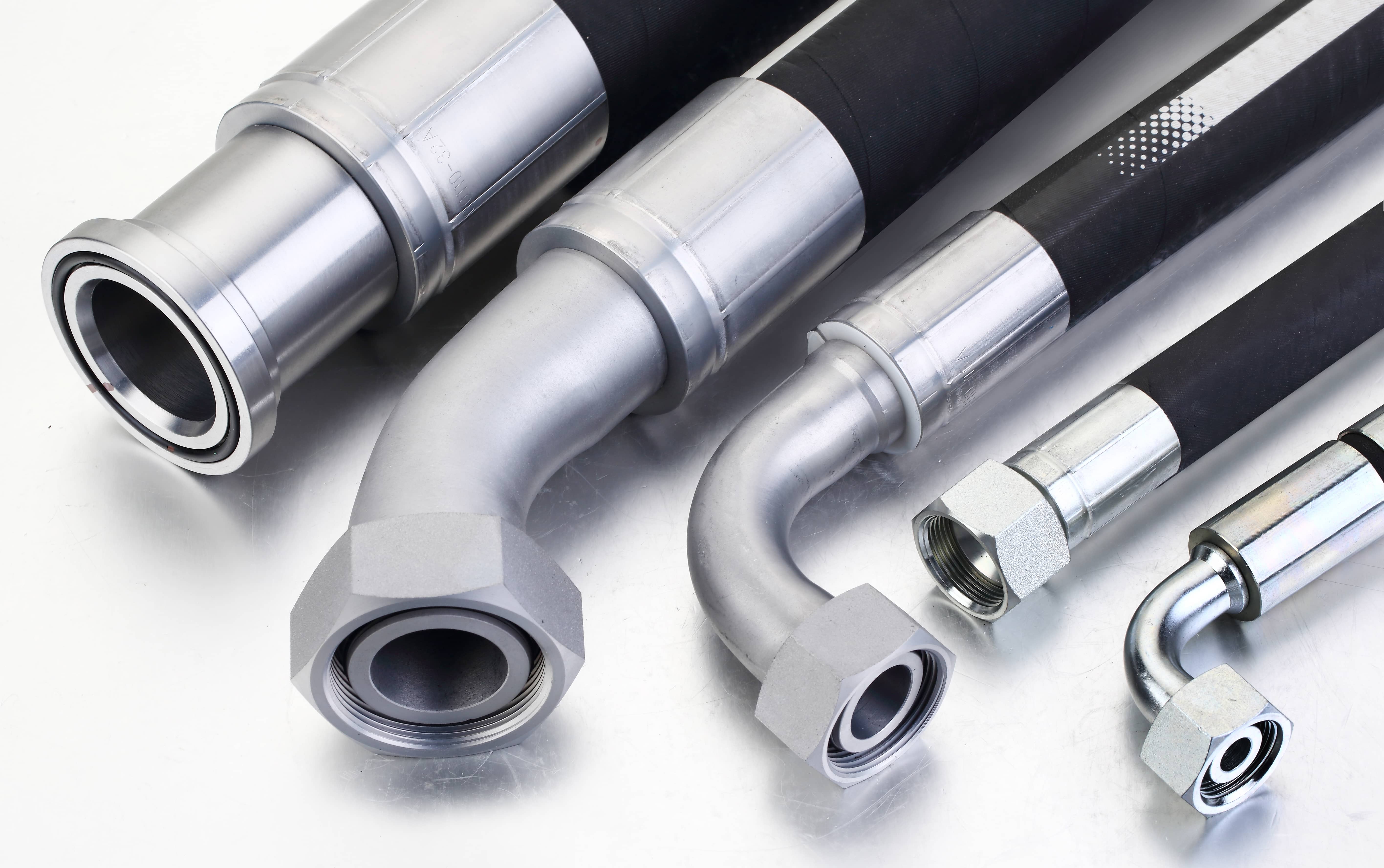 Assorted hydraulic hose assemblies featuring Flange DIN DKO JIC BSP and ORFS connection types from manufacturer