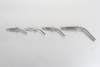 A 45 degree elbow hose stud making an angled transition on a flexible grease line to clear nearby machine components.