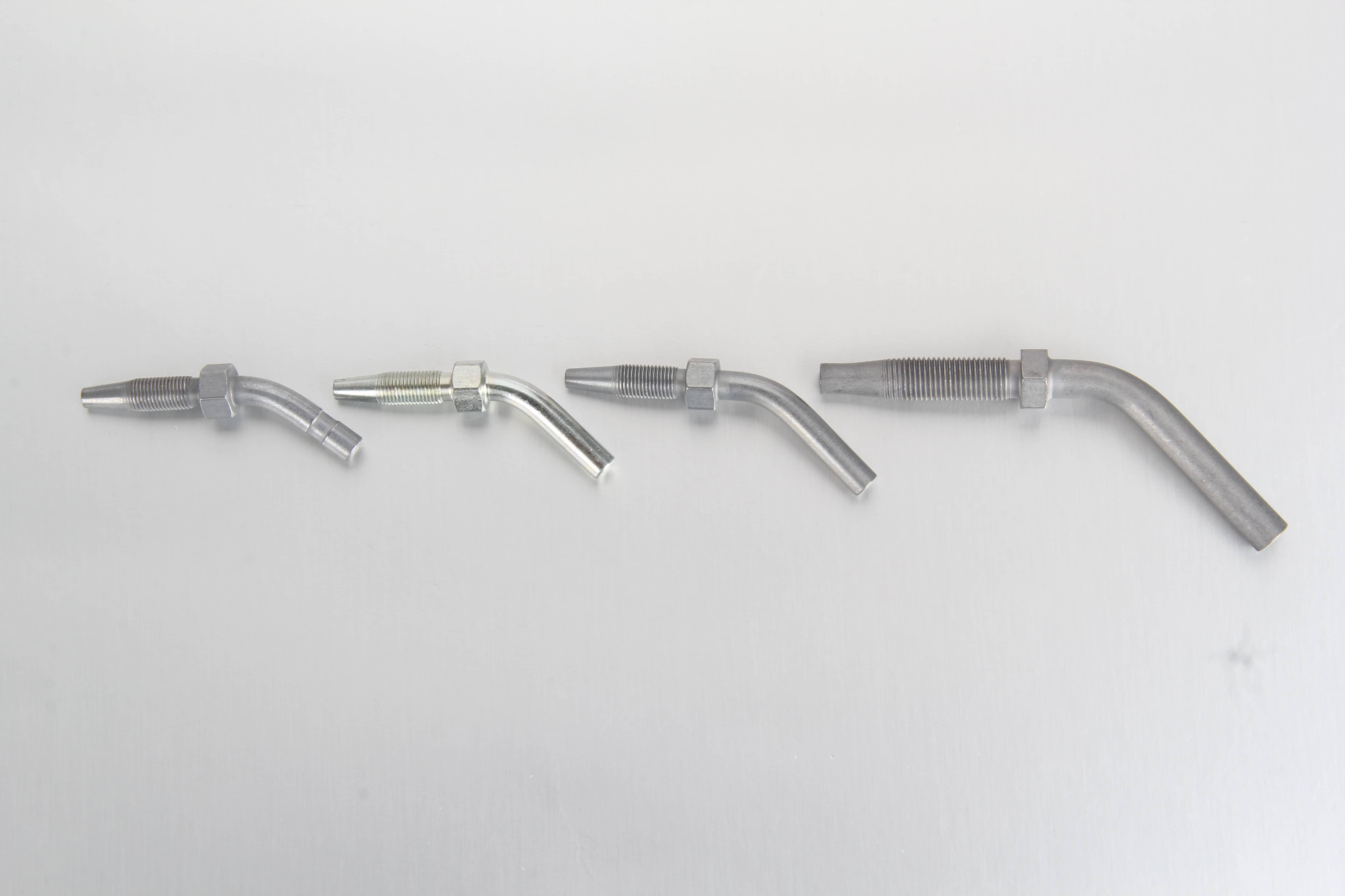A 45 degree elbow hose stud making an angled transition on a flexible grease line to clear nearby machine components.