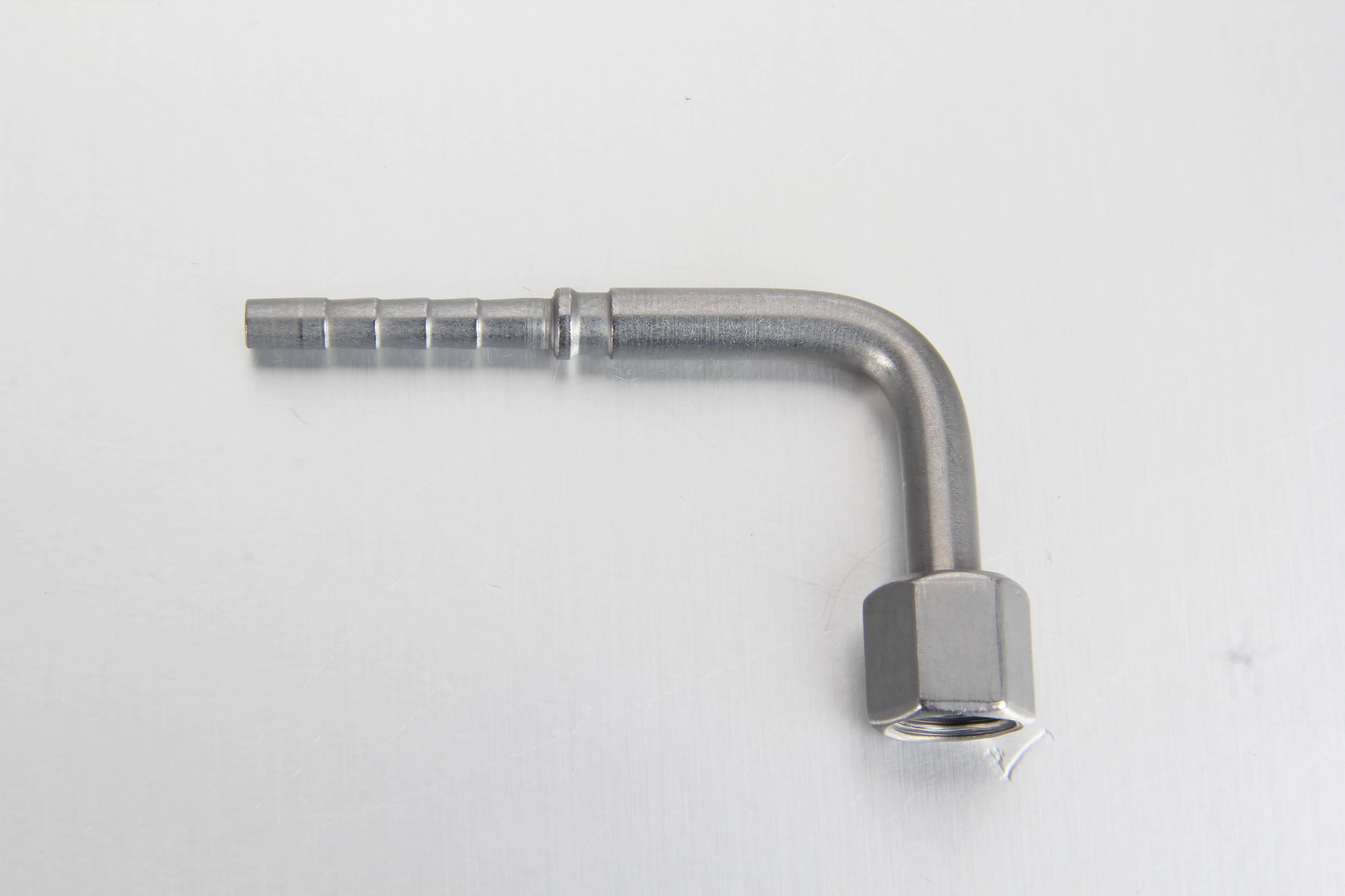 A professional white-background studio shot of a 90-degree elbow automatic lubrication hose fitting showing the push-on/crimp hose end and the metric DKOLL female swivel nut.